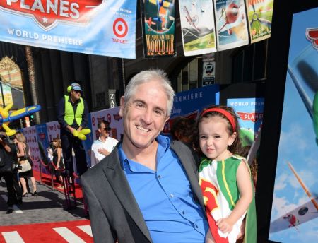Carlos with one of his daughters attending the premiere of Planes